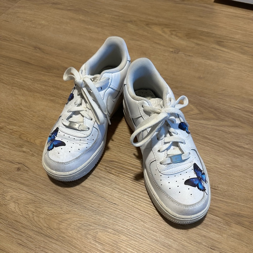 Customized white air force ones with blue butterfly’s. Size 8 women’s